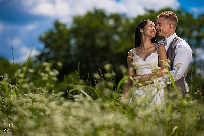 Wedding portrait in a grassy field