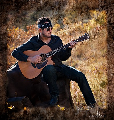 Playing guitar outside in the field