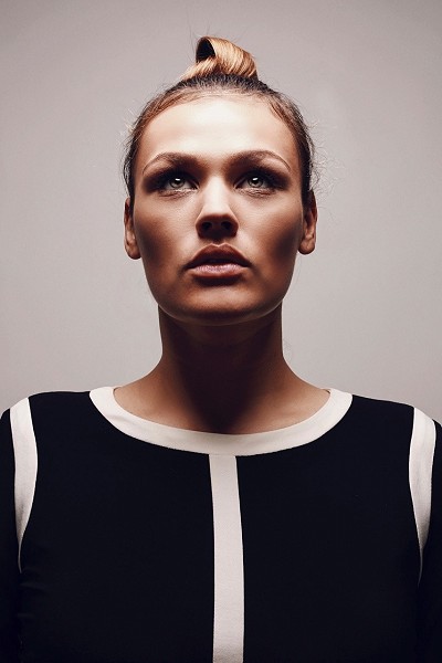 Blonde woman looking up into the light